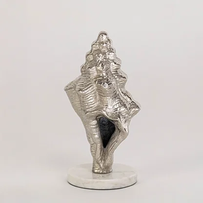 Artistic shell decor piece in silver finish for table decor or shelf styling contemporary home placement white background.