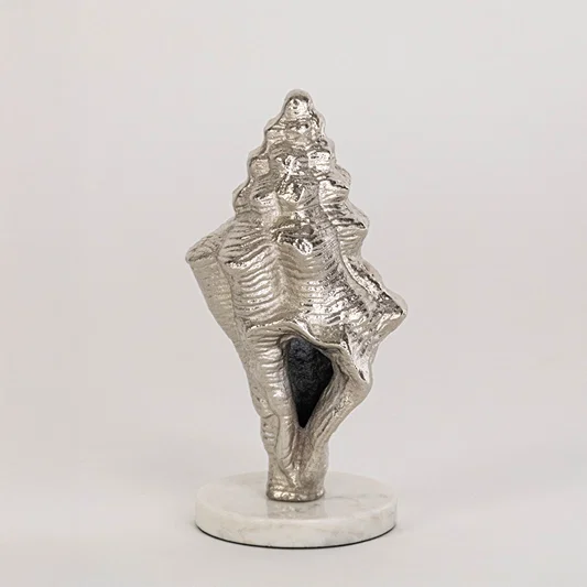 Artistic shell decor piece in silver finish for table decor or shelf styling contemporary home placement white background.