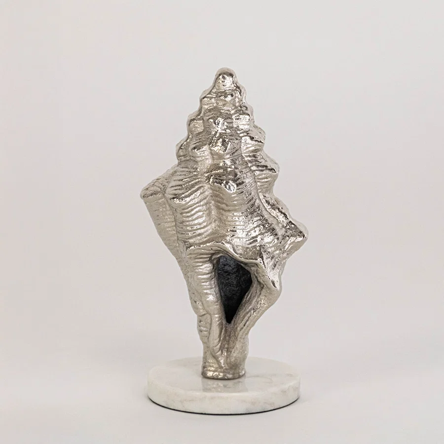 Artistic shell decor piece in silver finish for table decor or shelf styling contemporary home placement white background.