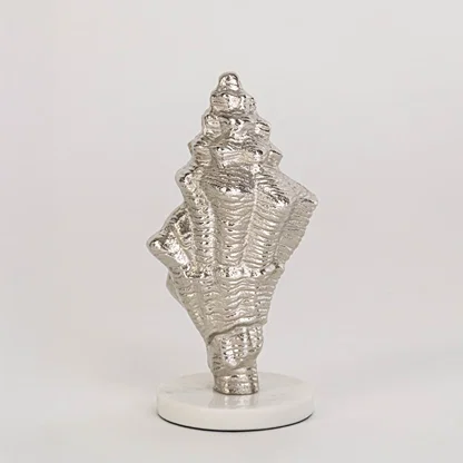 Textured silver conch shell decor on round white base clearly displayed against plain white background for showcase