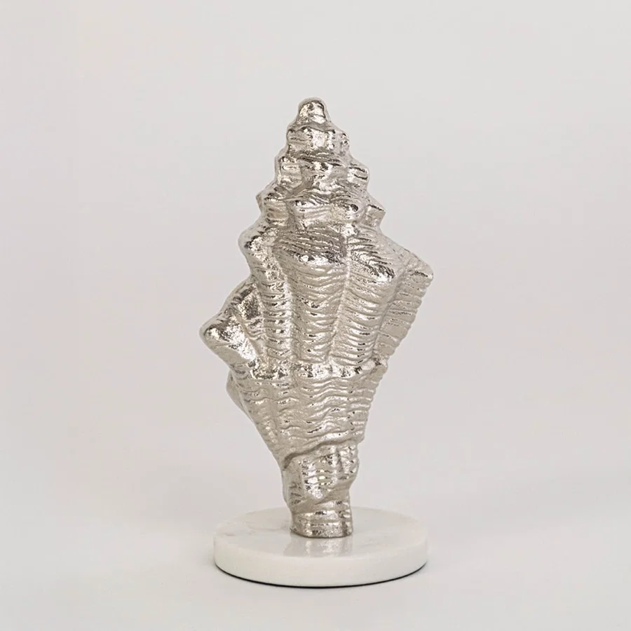 Textured silver conch shell decor on round white base clearly displayed against plain white background for showcase