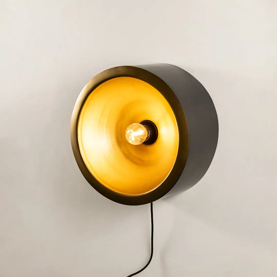 Wall light with round design and warm glow perfect for modern bedroom or hallway wall decor placement on clean background.