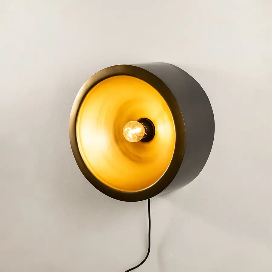 Wall light with round design and warm glow perfect for modern bedroom or hallway wall decor placement on clean background.