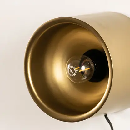 Closeup of wall light with gold metal dome shade showing smooth finish and modern design for interior wall decor styling.