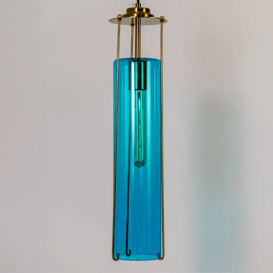 Blue glass pendant light illuminated to display sleek contemporary ceiling lighting with premium elegance.