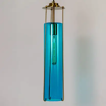 Blue glass pendant light illuminated to display sleek contemporary ceiling lighting with premium elegance.