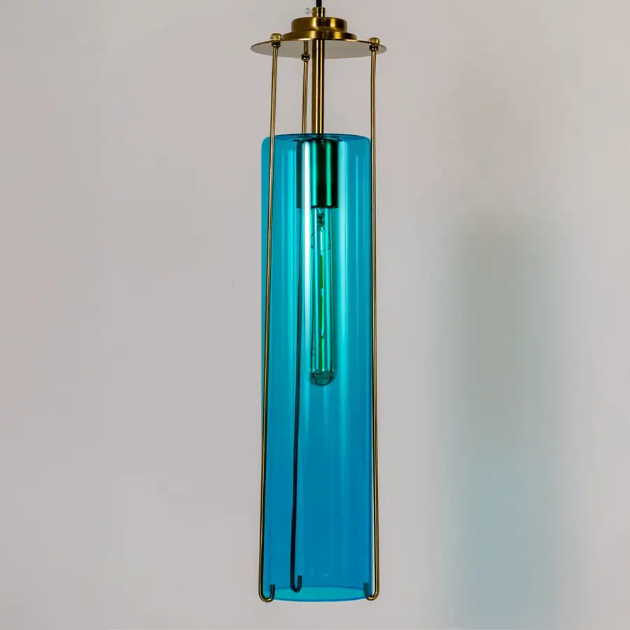 Blue glass pendant light illuminated to display sleek contemporary ceiling lighting with premium elegance.