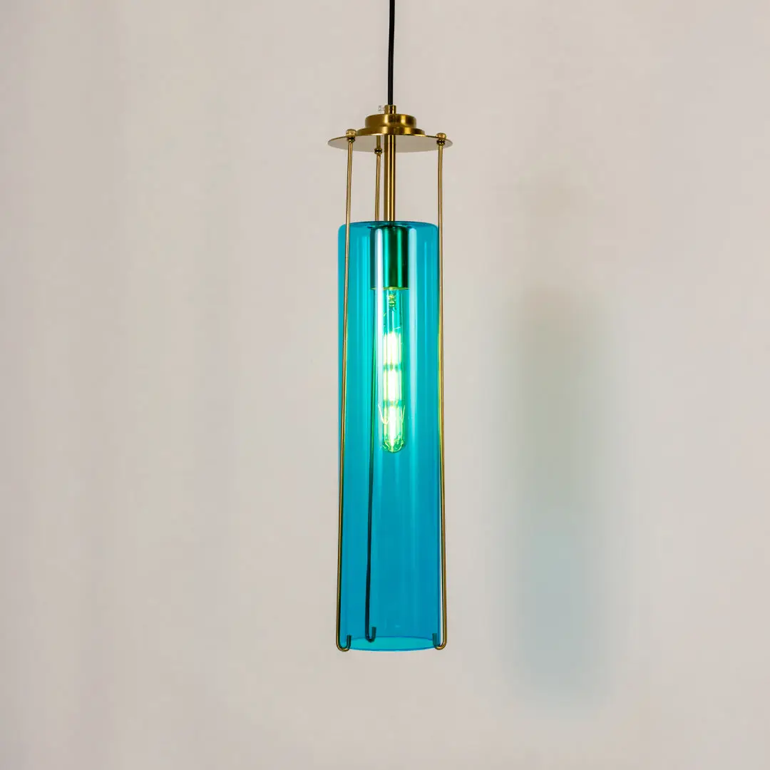 Modern pendant light in gold metal finish with blue glass tube shade for kitchen or dining decor lighting white background.