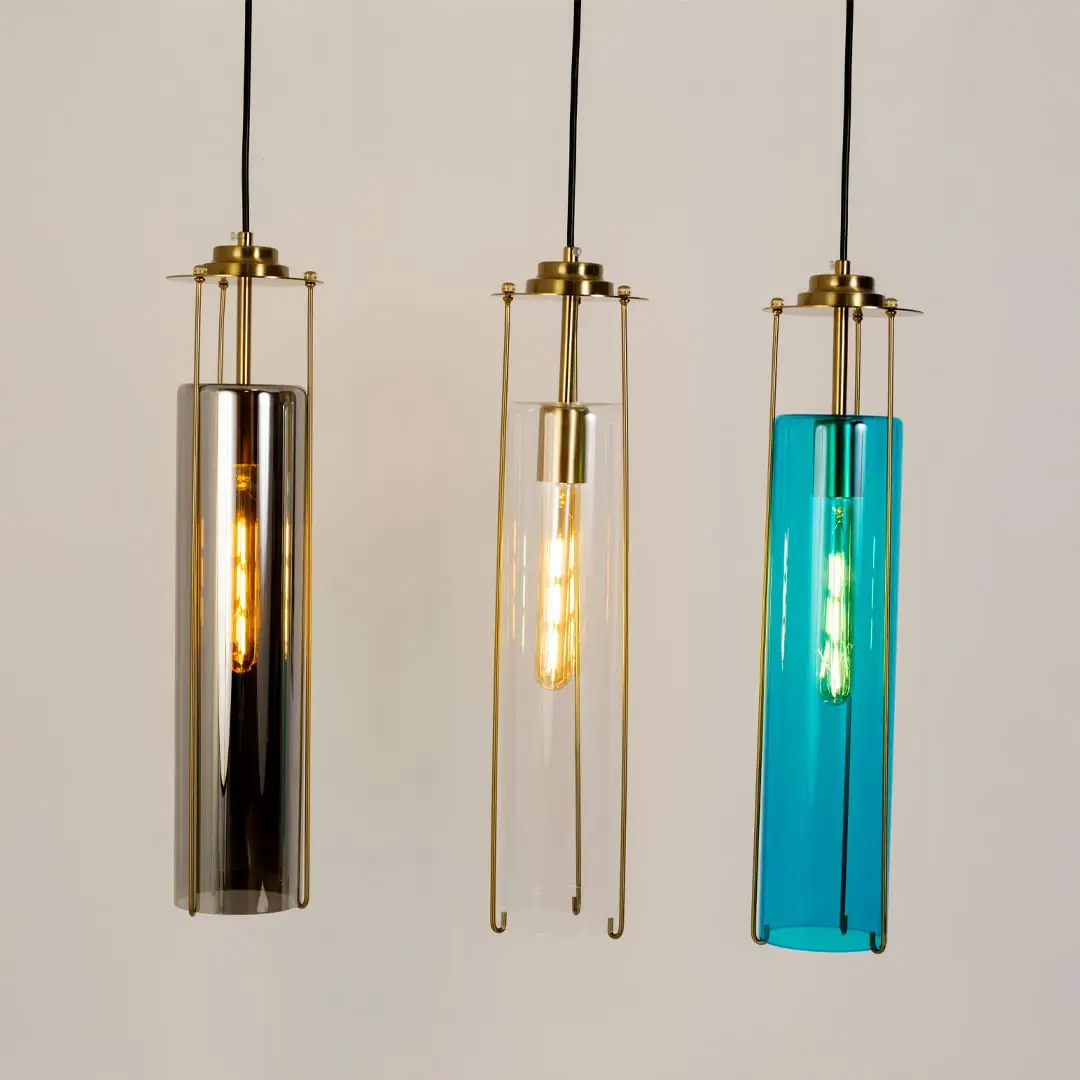 Smoke clear and blue glass pendant lights illuminated to showcase refined decorative ceiling lighting appeal.