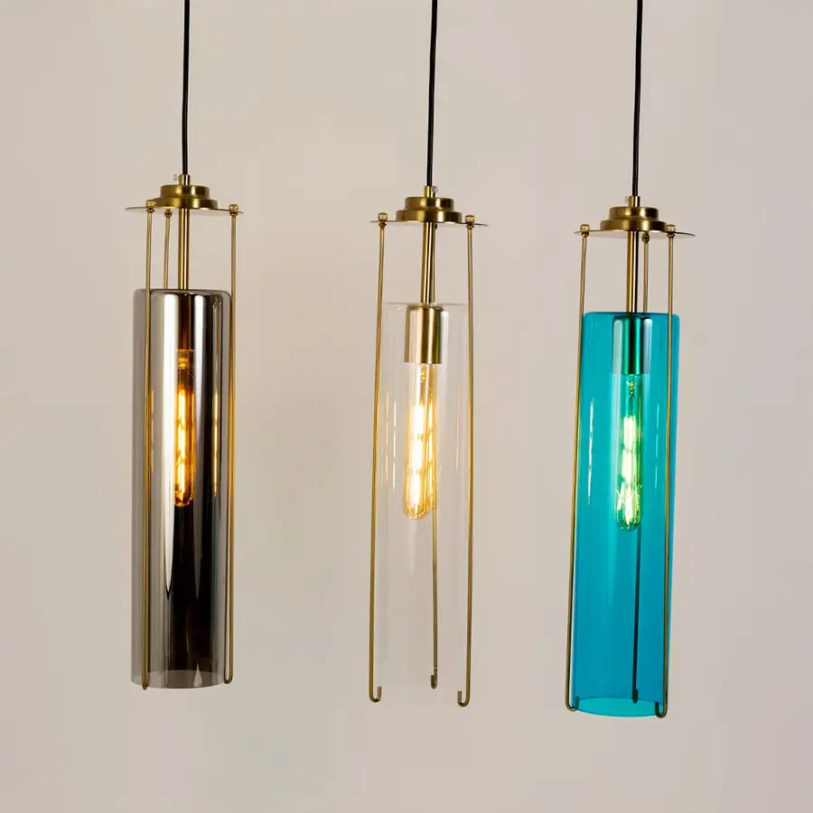 Smoke clear and blue glass pendant lights illuminated to showcase refined decorative ceiling lighting appeal.