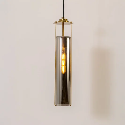 Smoke glass pendant light with gold metal fixture illuminated to display contemporary decorative ceiling lighting.