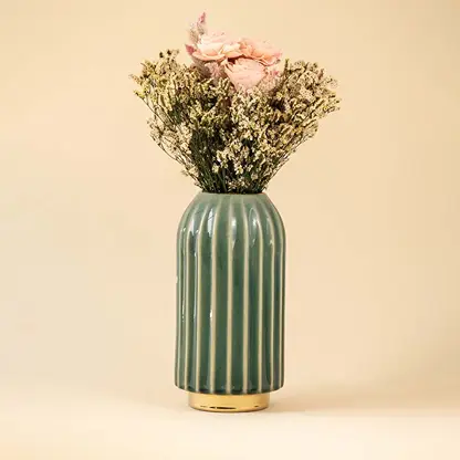 Ribbed green ceramic decorative vase with gold base styled as a premium accent piece for modern and contemporary home decor interiors.