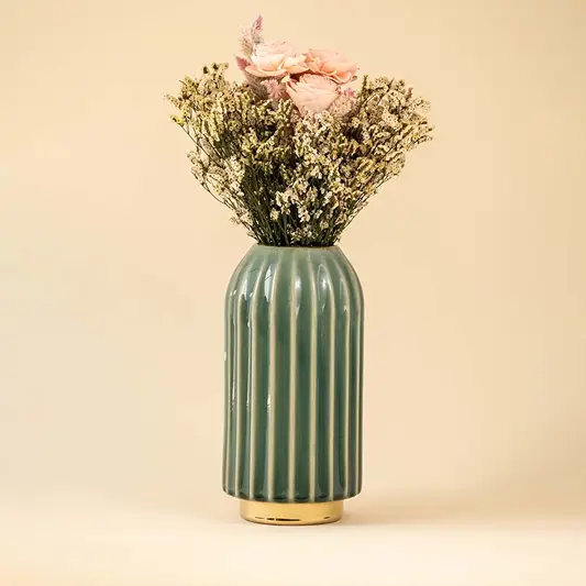 Ribbed green ceramic decorative vase with gold base styled as a premium accent piece for modern and contemporary home decor interiors.