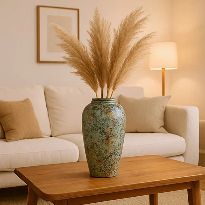 Green textured floor vase with pampas grass placed on table for elegant contemporary decor styling.