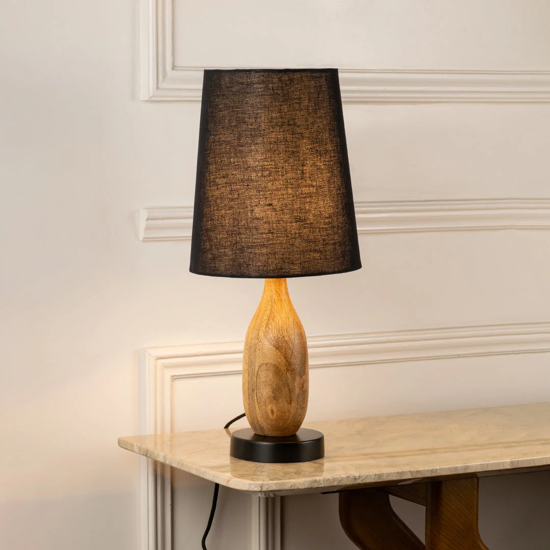 Table lamp with dark fabric shade and wooden base perfect for warm bedroom or living room table decor placement on clean background.