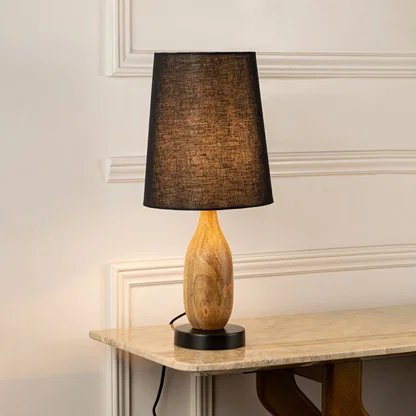 Table lamp with dark fabric shade and wooden base perfect for warm bedroom or living room table decor placement on clean background.