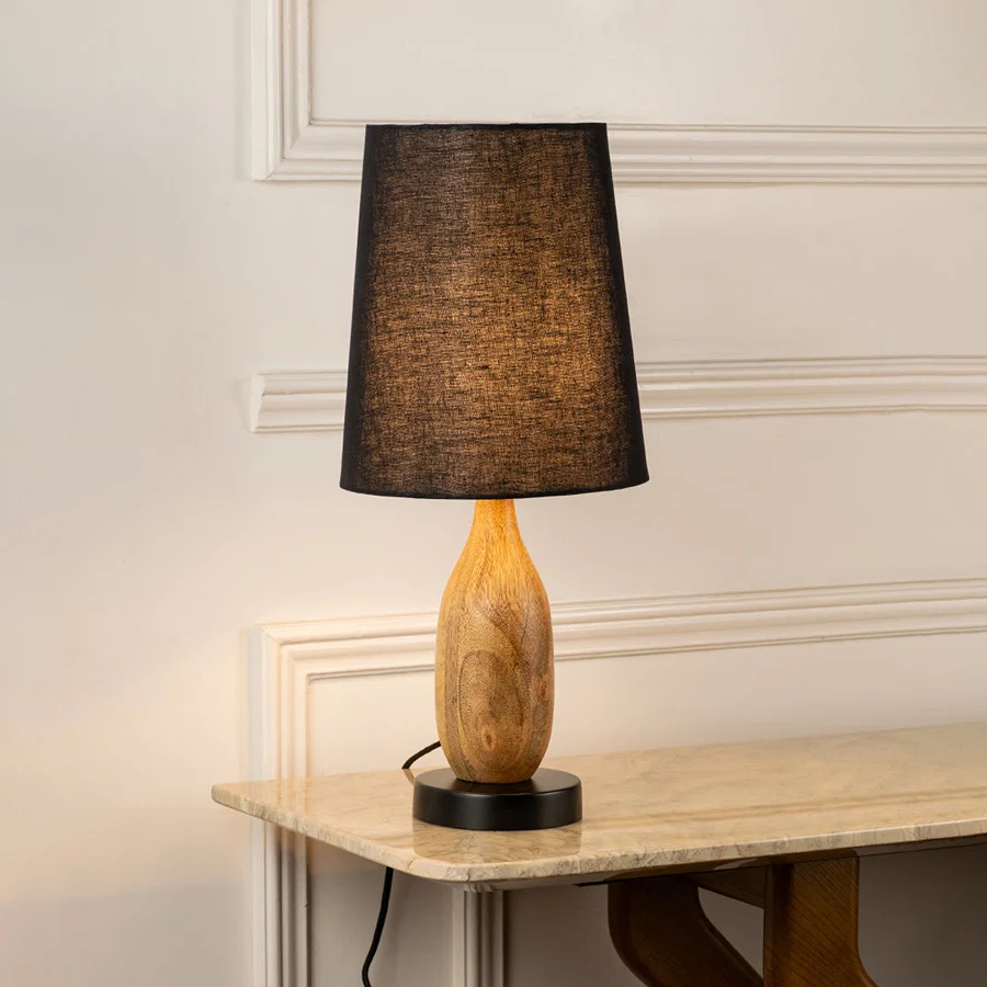 Table lamp with dark fabric shade and wooden base perfect for warm bedroom or living room table decor placement on clean background.