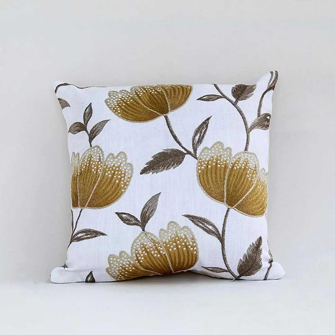 White cotton cushion cover with large golden botanical motifs providing a premium nature inspired décor accent with a breathable soft and skin friendly material finish.