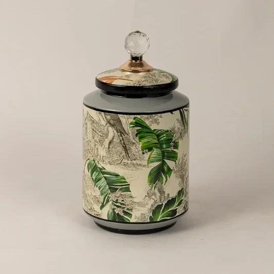Side angle of tropical bird jar showing smooth cylindrical shape glossy finish and tropical foliage design.