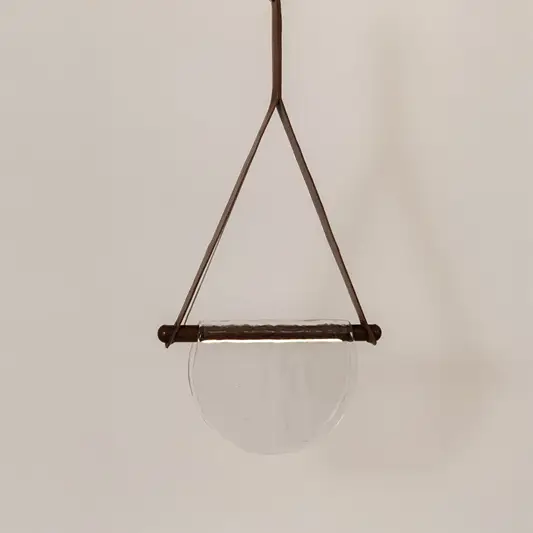 Brown metal pendant light with smoke glass diffuser featuring minimalist decorative styling.