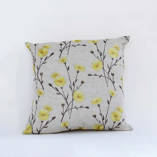 White cotton cushion cover with yellow floral print for sofa bedroom seating and fresh modern home decor styling.