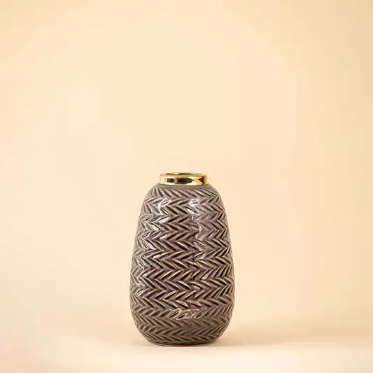 Grey ceramic decorative vase with textured geometric pattern and gold rim for elegant modern home decor styling.