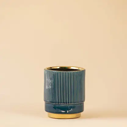 Blue ceramic table decor vase with textured finish and gold rim ideal for living room shelf styling on clean white background.