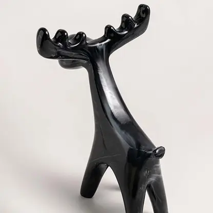 Black ceramic moose figurine with marble swirl detail shown from side angle for decorative styling reference.