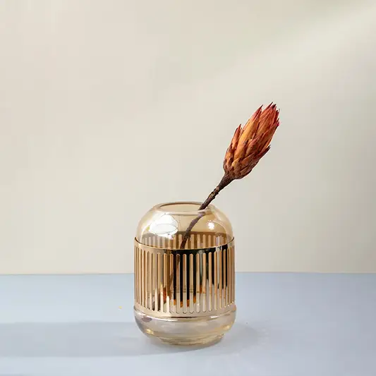 Amber glass vase with gold striped design holding dried flower styled on table for modern home interior decor glass vase.