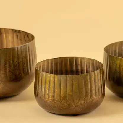 Bronze ribbed metal bowl planter closeup showing textured finish perfect for shelves tables and natural modern decor.