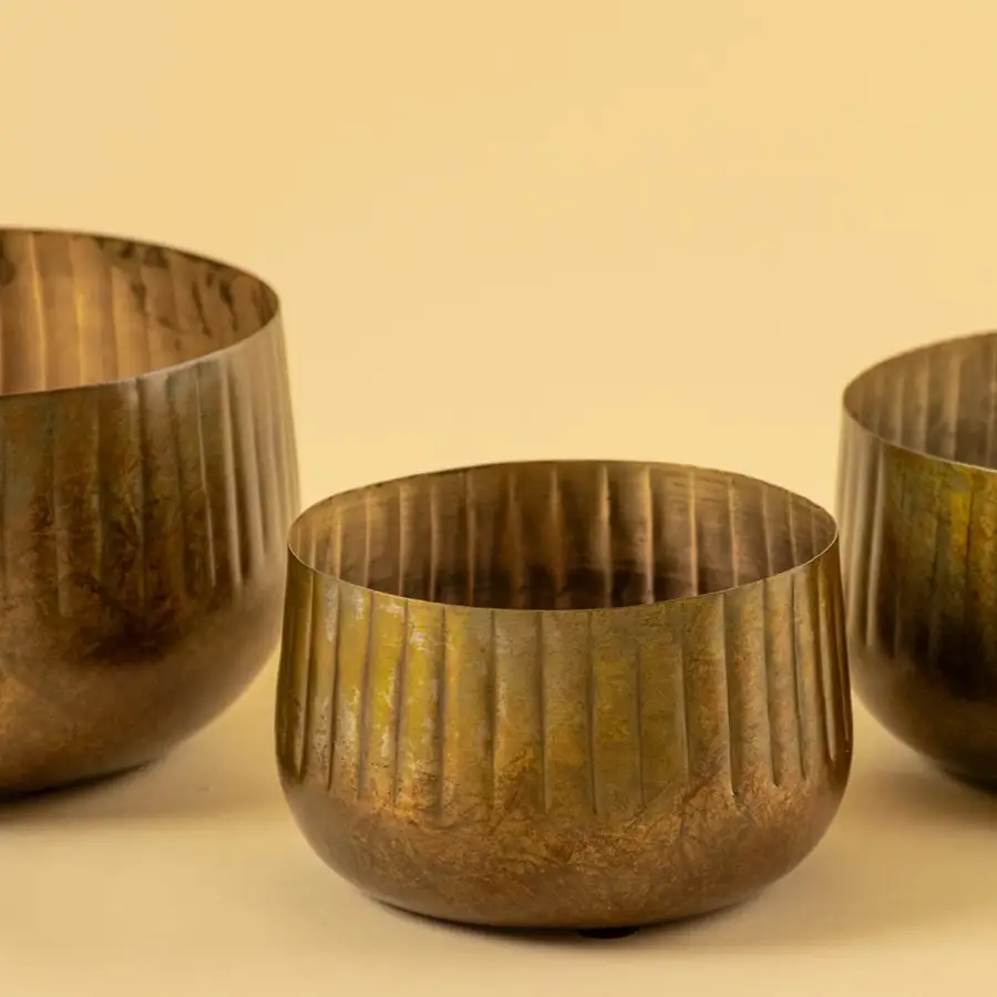 Bronze ribbed metal bowl planter closeup showing textured finish perfect for shelves tables and natural modern decor.