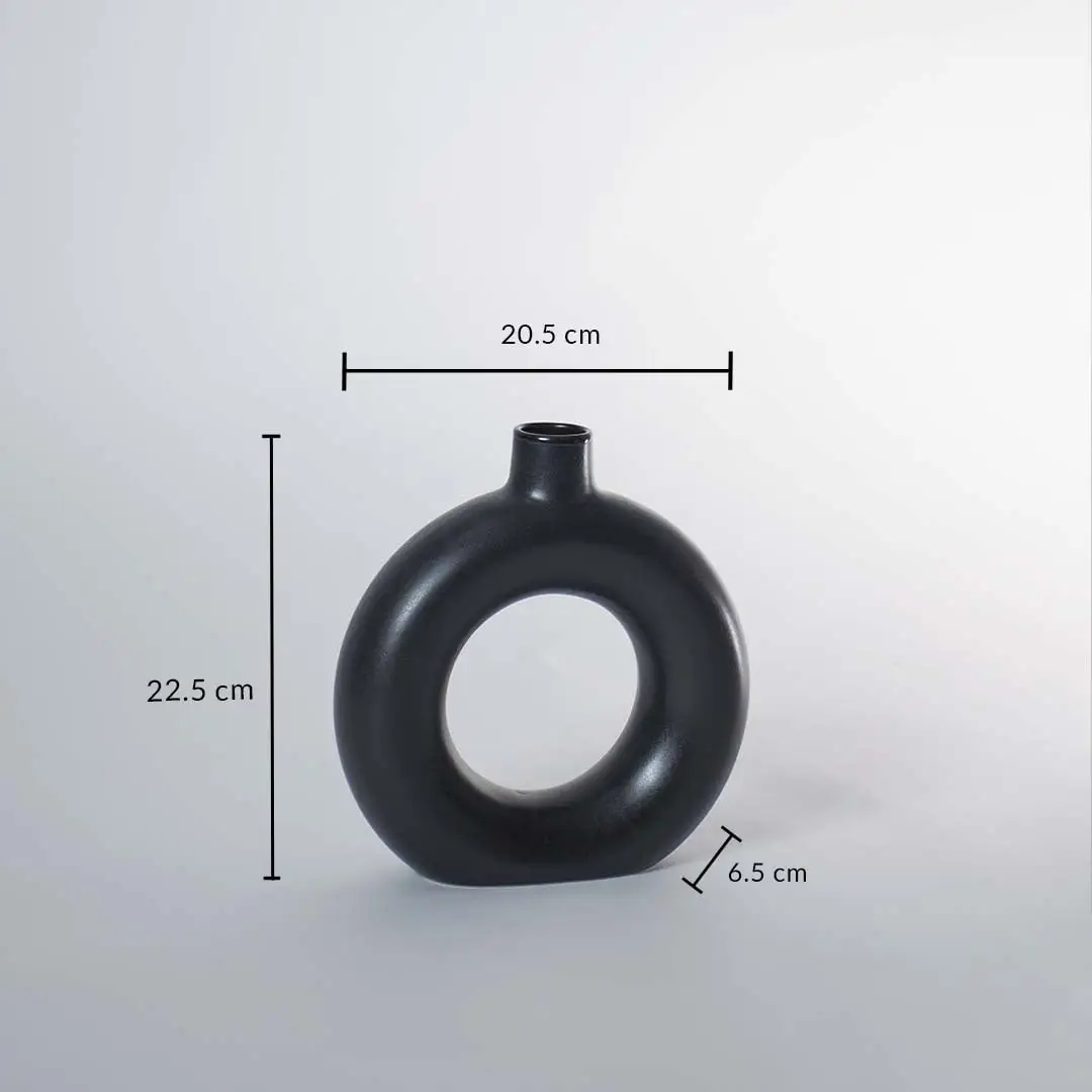 Black ceramic donut vase with matte finish measuring 22.5 cm height 20.5 cm width and 6.5 cm depth for stylish decor.