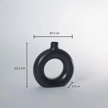 Black ceramic donut vase with matte finish measuring 22.5 cm height 20.5 cm width and 6.5 cm depth for stylish decor.
