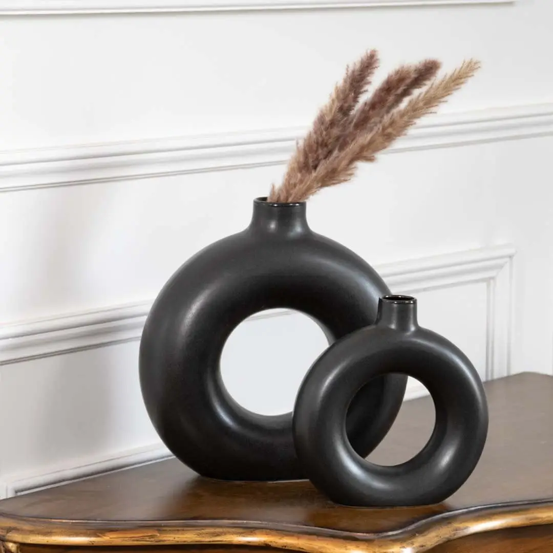 Set of two modern black ceramic donut vases with matte finish perfect for pampas grass and table decor styling.