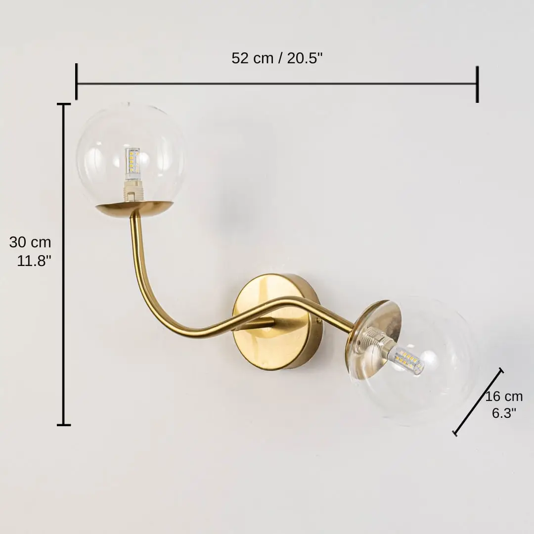 Clear glass globe double arm wall lamp with gold base, base 30 x 12 x 40 cm (11.8 x 4.7 x 15.7 inches), canopy 10 x 10 cm (3.9 x 3.9 inches) dimensions
