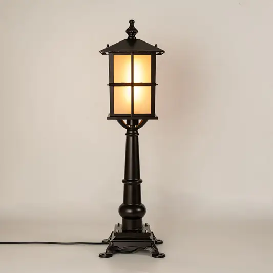Black outdoor gate light with warm glowing panels for luxury exterior decor styling use.