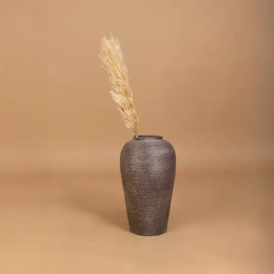 Brown rustic tall vase placed in a curated home setting enhancing consoles shelves and living spaces with natural earthy decorative appeal.