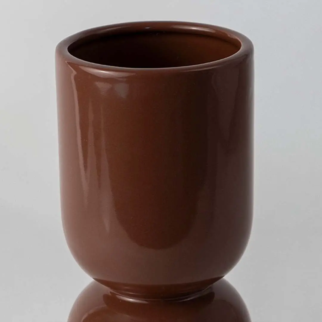 Closeup of brown ceramic decorative vase with glossy finish showcasing premium craftsmanship and elegant styling.