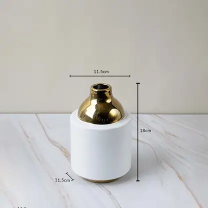 Ceramic vase with glossy white body golden neck size 18cm height 11.5cm width perfect for home tabletop decoration.