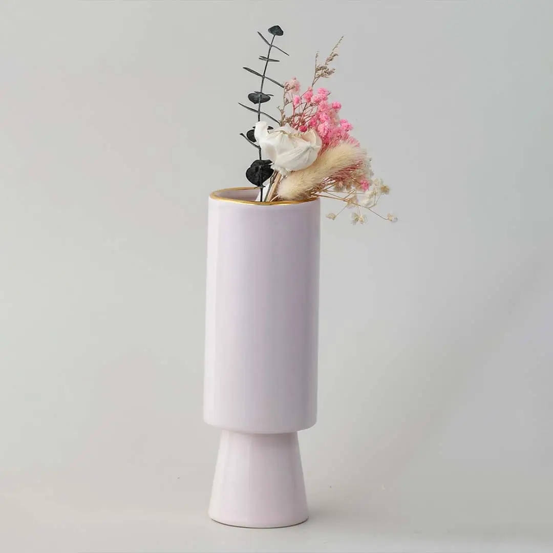 Soft toned decorative vase in blush pink shown in a minimal lifestyle scene emphasizing its sleek shape and gentle modern style.