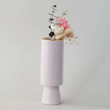 Soft toned decorative vase in blush pink shown in a minimal lifestyle scene emphasizing its sleek shape and gentle modern style.