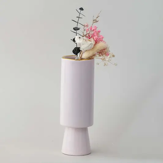 Soft toned decorative vase in blush pink shown in a minimal lifestyle scene emphasizing its sleek shape and gentle modern style.