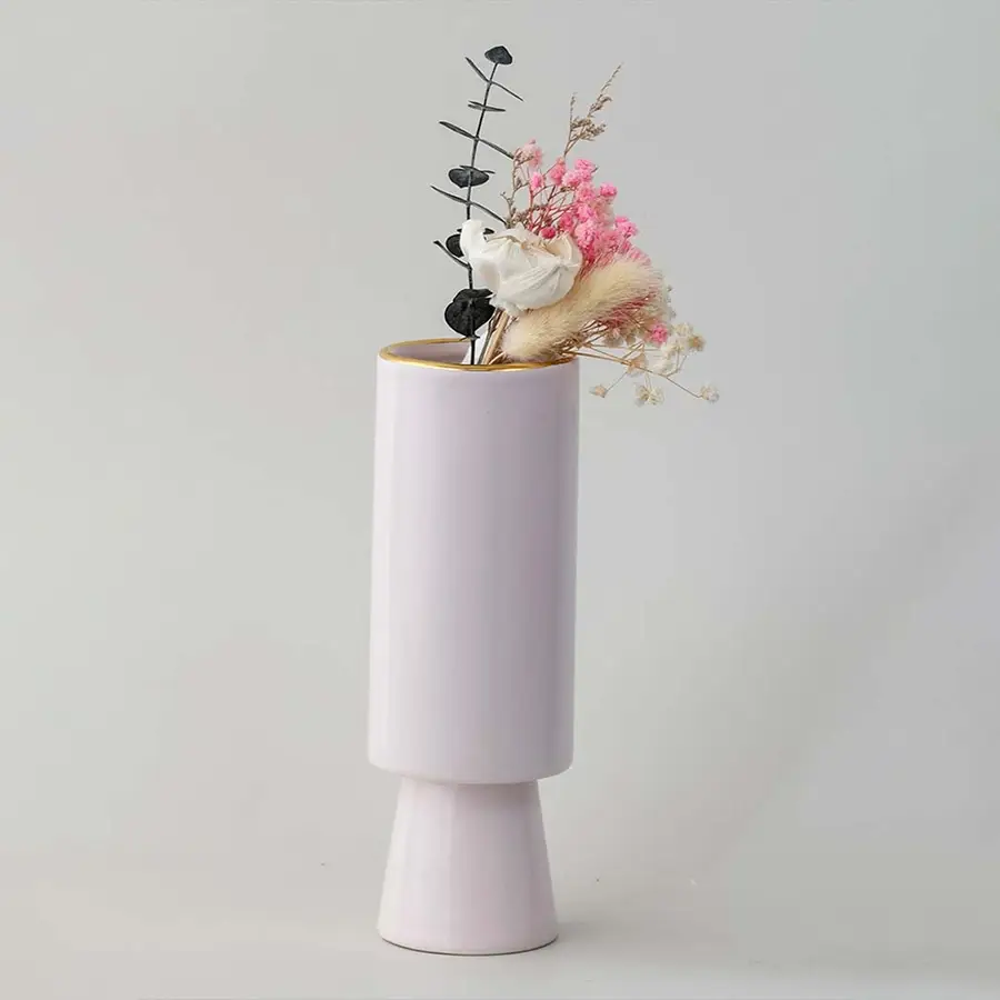 Soft toned decorative vase in blush pink shown in a minimal lifestyle scene emphasizing its sleek shape and gentle modern style.