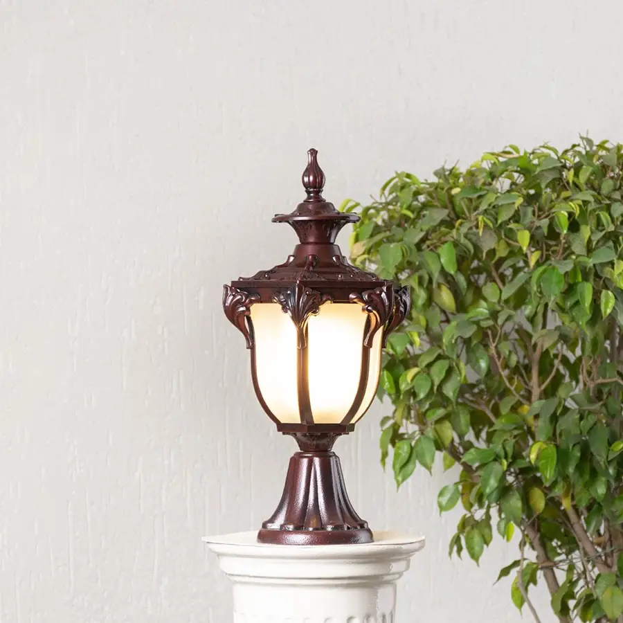 Elegant outdoor brown metal pillar lamp glowing with frosted glass shade perfect for balcony entrance and garden decor.