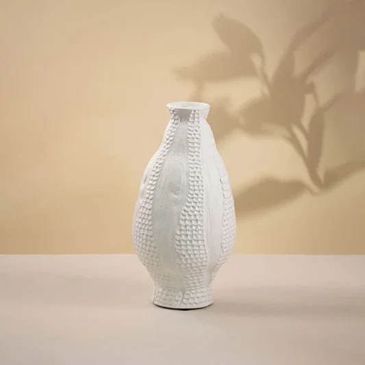 White ceramic decorative vase with woven texture and bottle silhouette for sophisticated tabletop styling and decor.