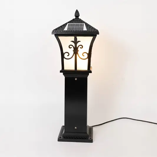 Vintage black outdoor gate light with warm glowing glass panels for elegant exterior decor use.