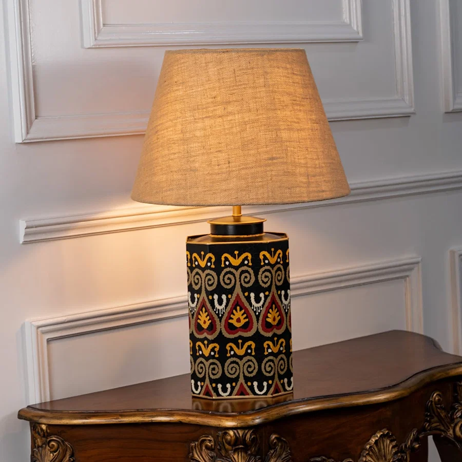 Festoon Damask table lamp illuminated on white background highlighting classic pattern warm glow and timeless interior decor elegance.