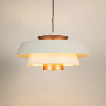 White and copper metal pendant light glowing warmly on white background creating stylish ambience for home office cafe and more spaces.