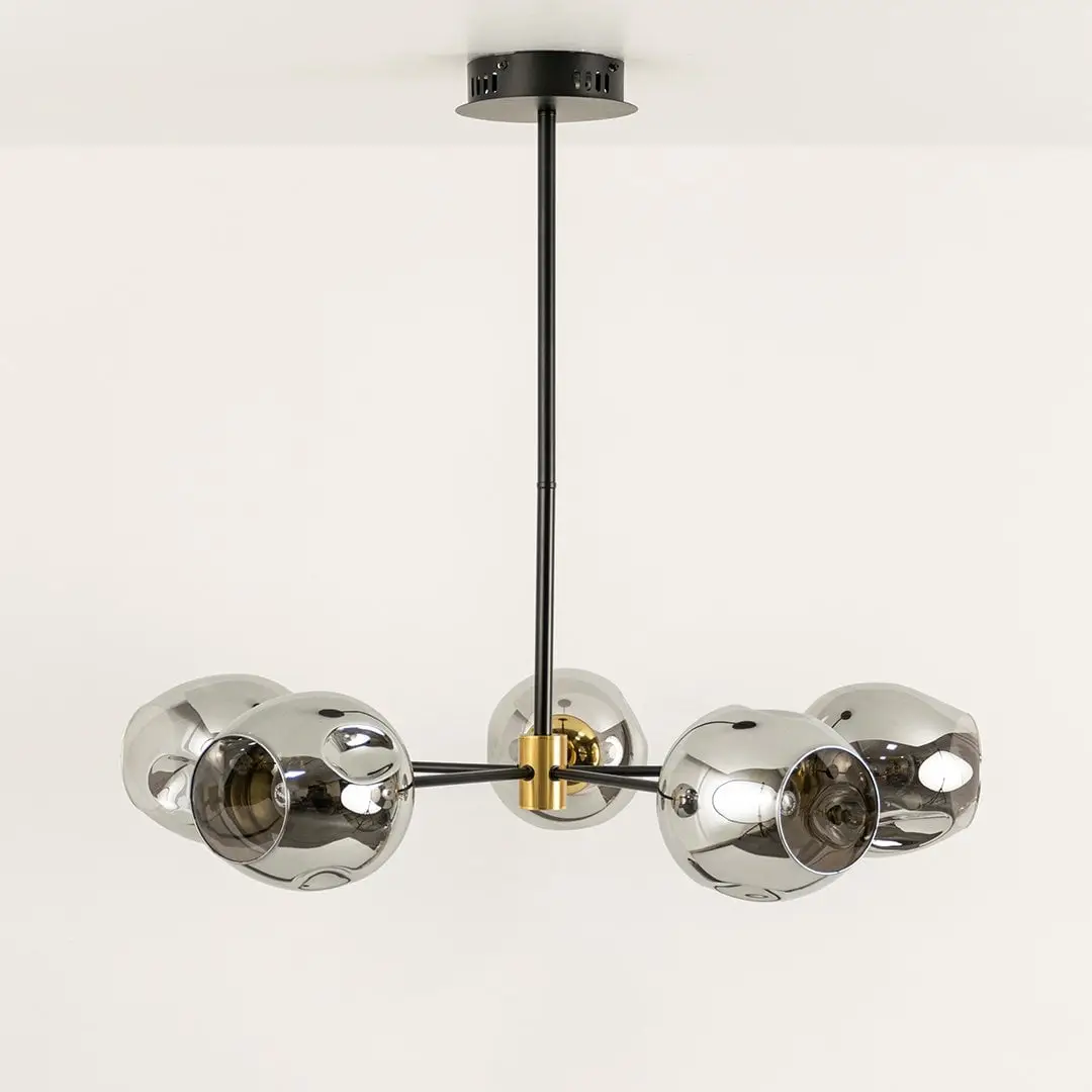Smoked chrome glass chandelier displayed on white background with light off showing sleek design gold joints and artistic modern structure.