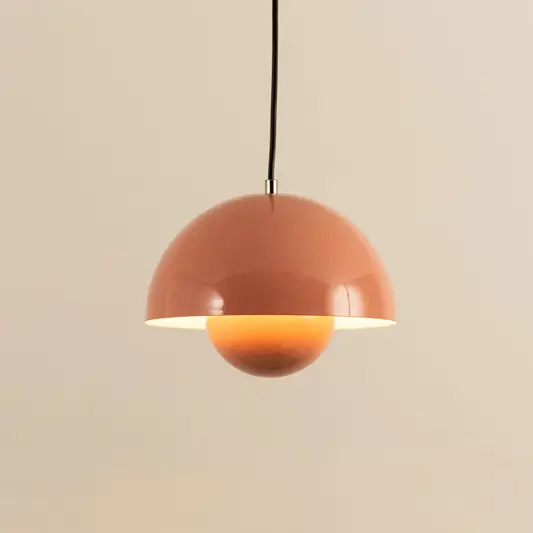 Peach metal pendant light with layered shade and smooth finish crafted for stylish interiors.